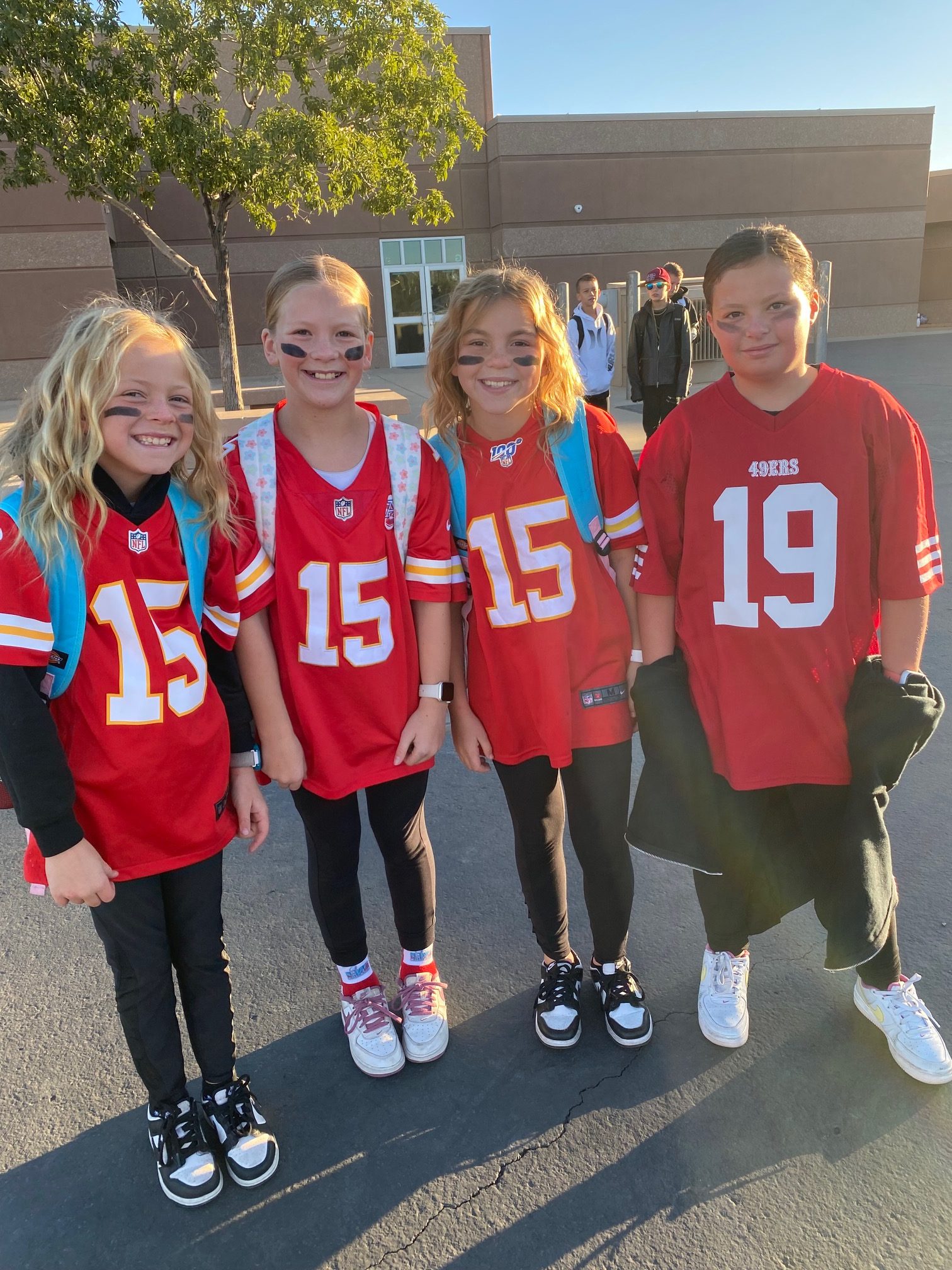Four students in football jerseys