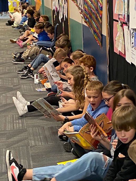 Students reading in hallway