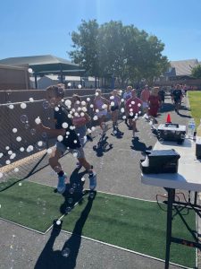 students running through bubbles